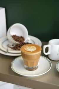 Creamy latte with elegant art at a quaint café in İstanbul, perfect for coffee lovers.